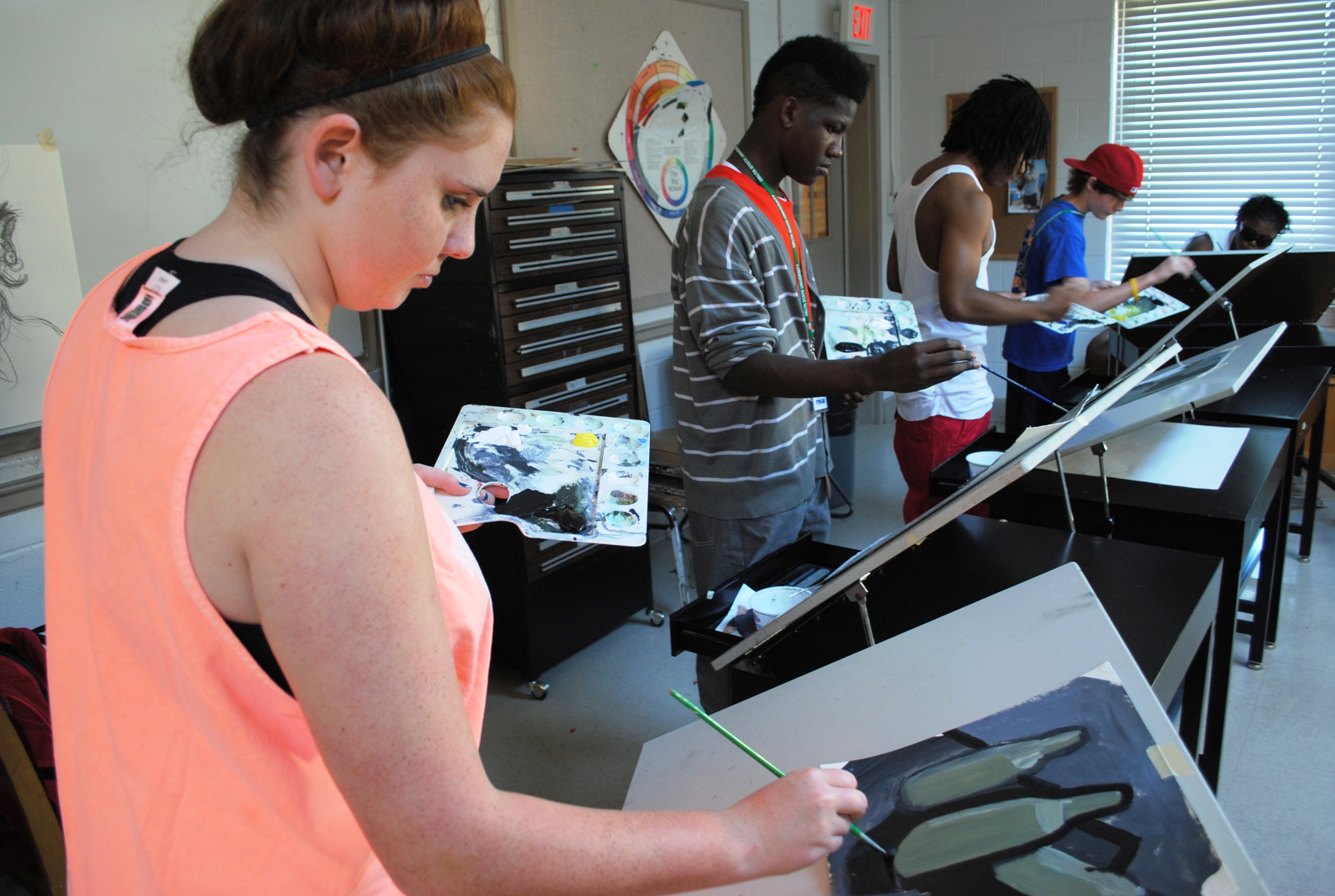 Photo: 2012 Arts campers participate in a painting course.